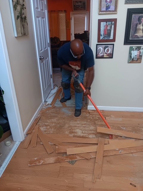Old flooring being removed from a room during the flooring project