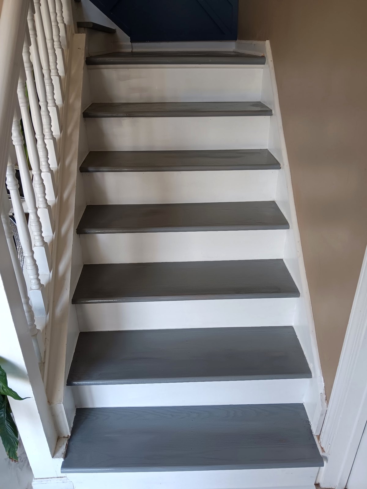 Refinished staircase with gray painted treads and white risers