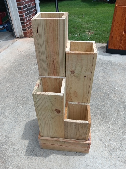 Tiered custom wooden plant stand built from natural, unfinished wood